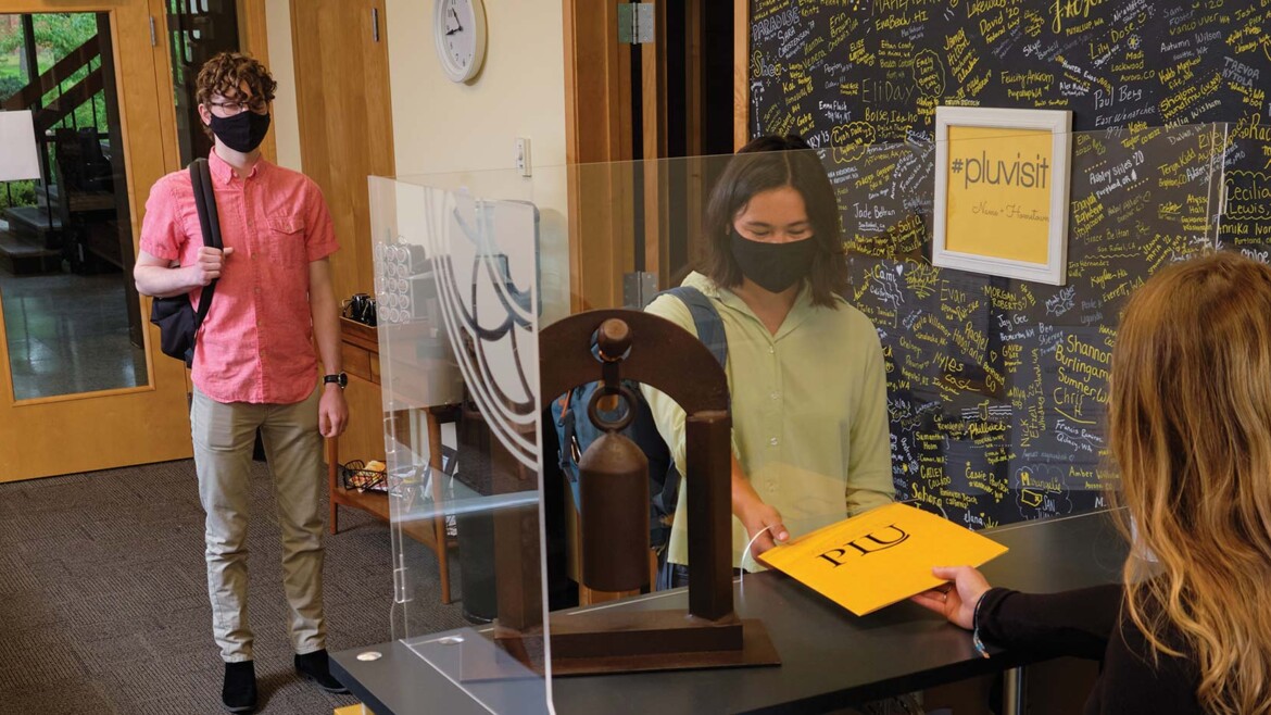 PLU students in the Welcome center wearing protective masks