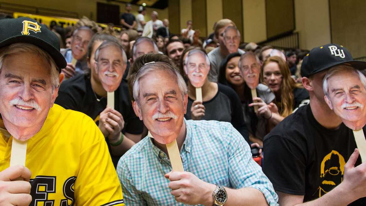 Fans holding Coach Dickerson face cutouts at PLU men's basketball vs Linnfield, Friday, Feb. 17, 2017. (Photo: John Froschauer/PLU)