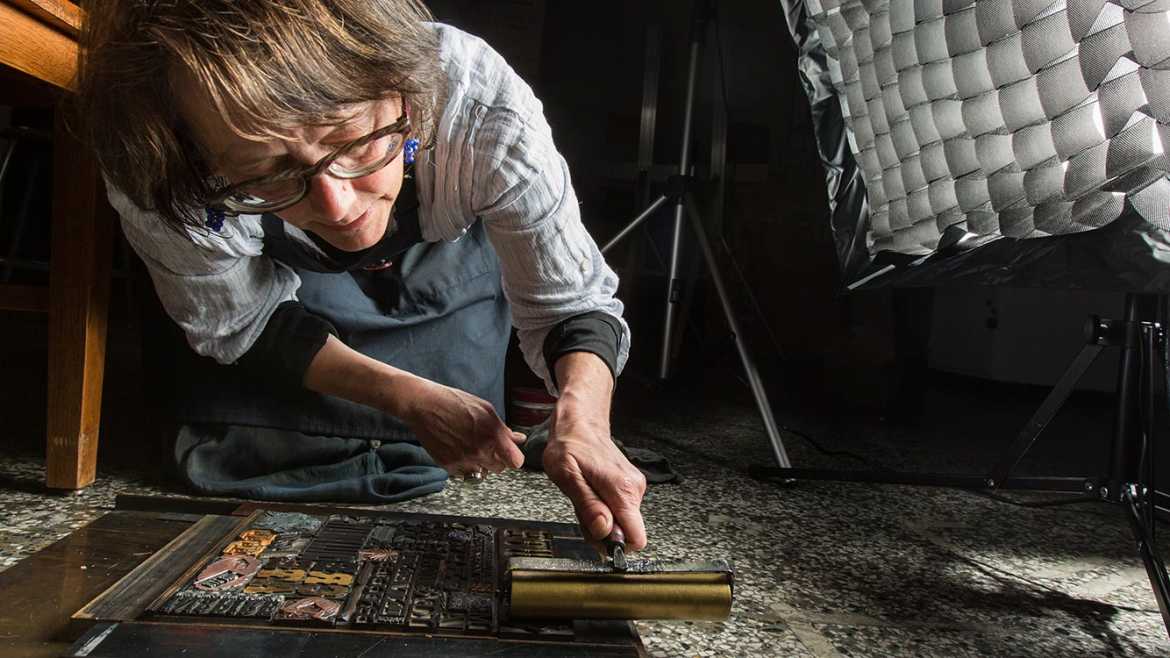 Jessica Spring carefully rolls a layer of metallic gold varnish onto the chase lockup featured on the cover of the spring issue of ResoLute. Spring, with assistance from colleague Mare Blocker, crafted the design out of wood and metal type from the Thorniley Collection, a major donation that has expanded Pacific Lutheran University’s letterpress collection.