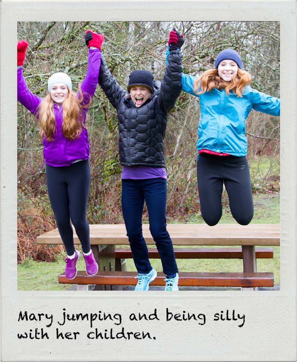 Mary jumping and being silly with her children.