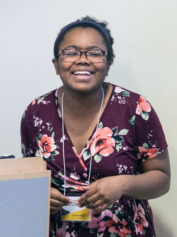 Cynthia Waite '20 - smiling while presenting her research