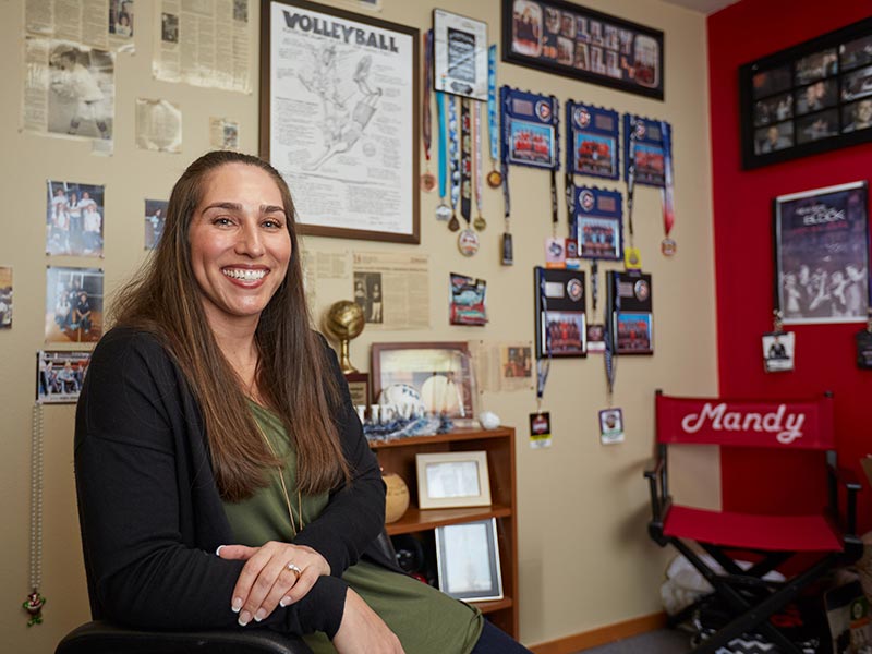 Mandy Flores-Handley, a two-sport PLU Hall of Fame inductee poses in her office and by Lake Spanaway