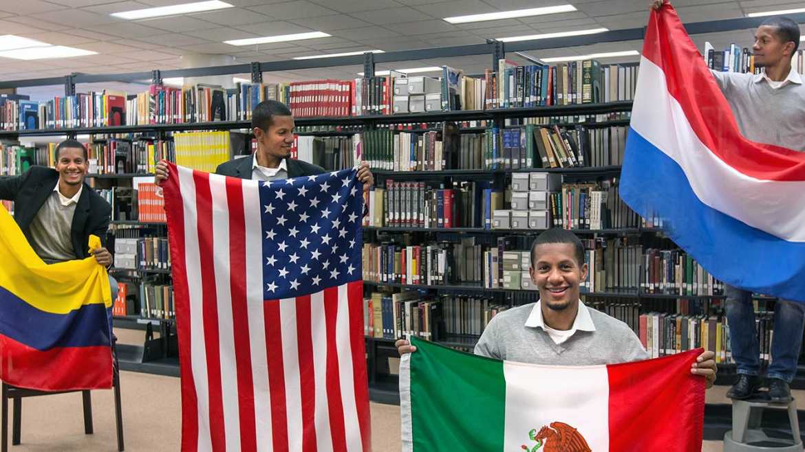 Jake Taylor standing with a bunch of different flags