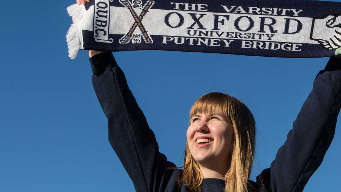 Molly Lindberg ’17 poses and holds an Oxford University scarf over her head