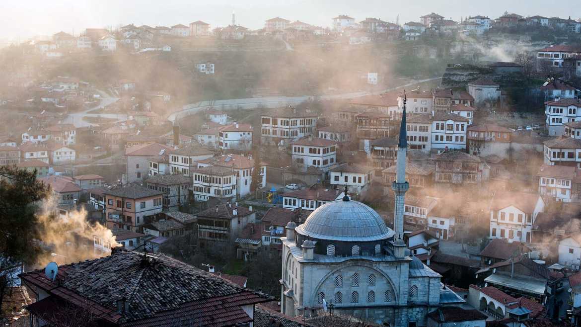Clouds cover the buildings and town in a town in Turkey