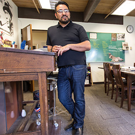 Jp Avila standing near a desk