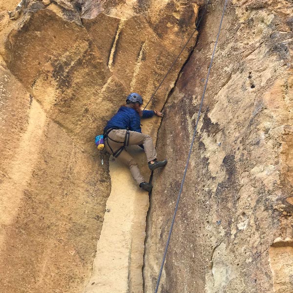 Current Outdoor Rec - climbing up a cliff wall