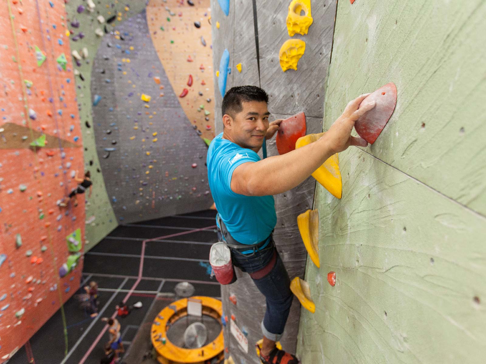 Eddie Espinosa climbing up an indoor wall