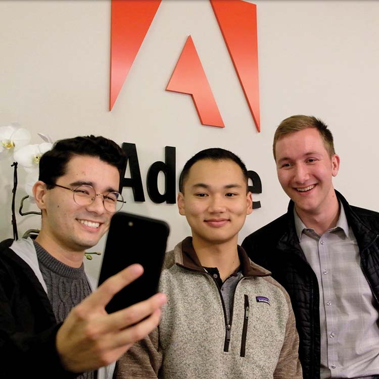 Business students stop for a selfie during a visit to the Seattle offices of Adobe.