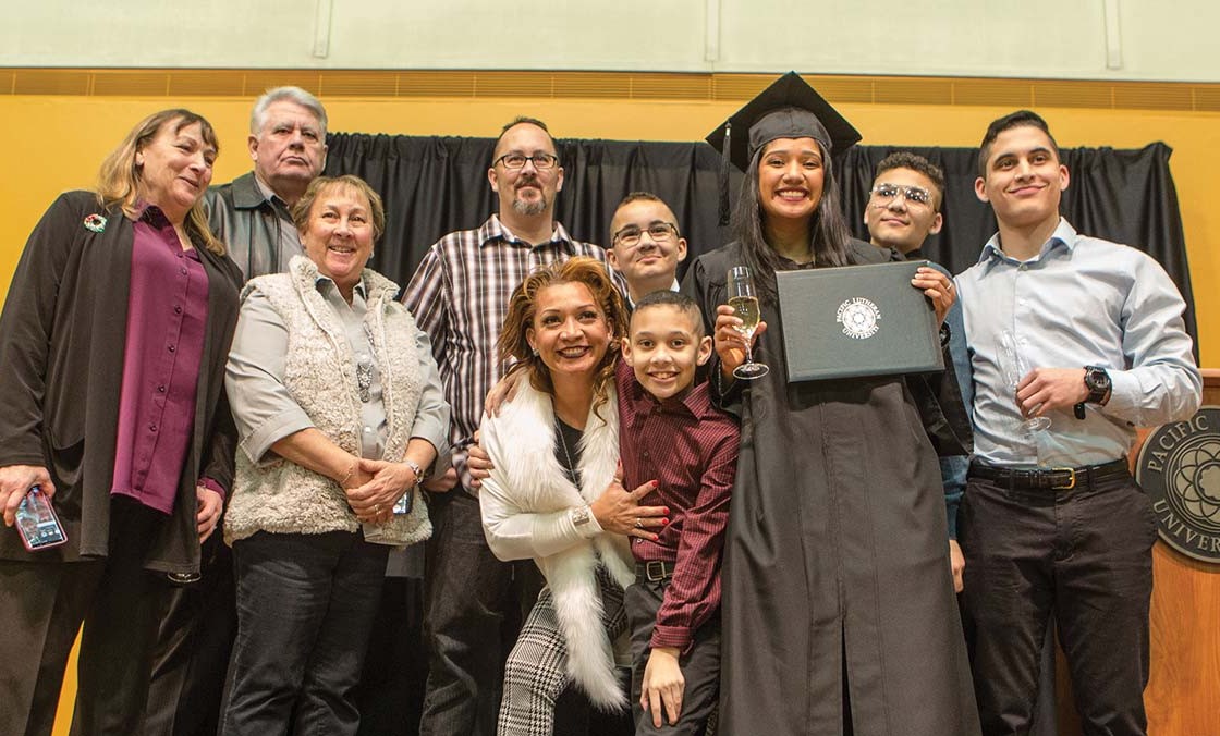 Denis Julio and her family gather with others for a reception.