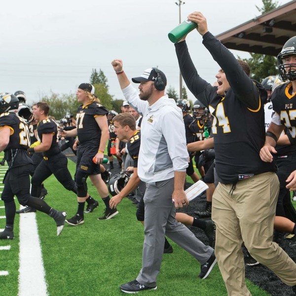 New football coach Brant McAdams pumps the air after Lutes achieve victory over the Claremont-Mudd-Scripps team.