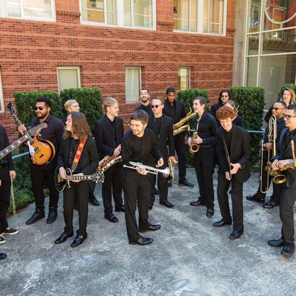 Members of the PLU Jazz Ensemble hang loose as they prepare for a group photo with new director of jazz studies Cassio Vianna, left.