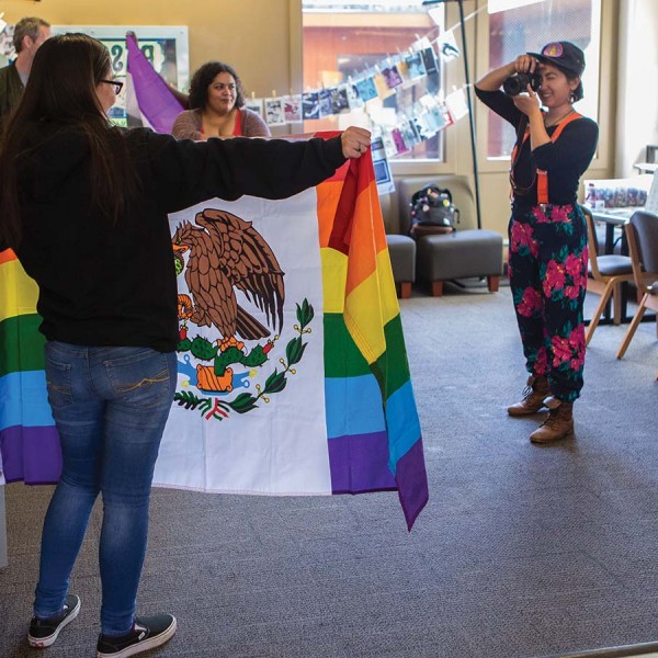 Students pose with their chosen flags for National Coming Out Day.