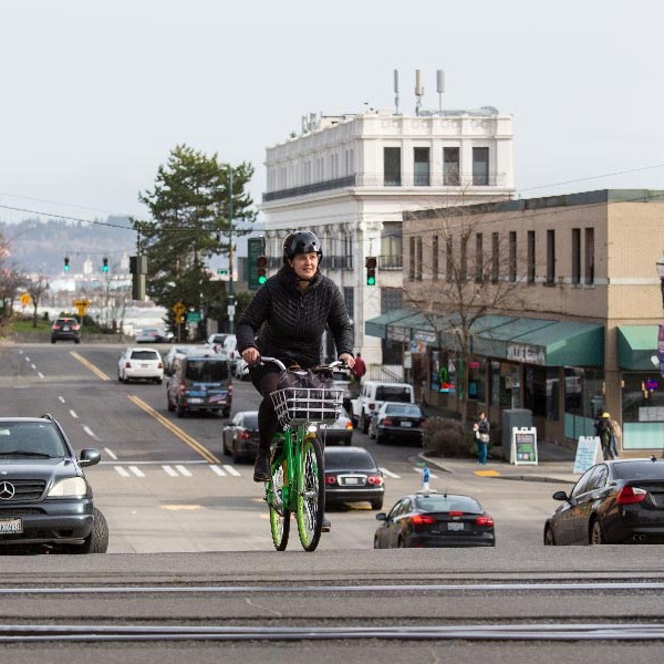 Kristina Walker, Executive Director of Downtown: On 1he Go, rides a lime bike in Downtown Tacoma