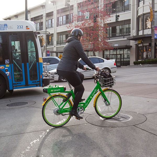 Kristina Walker, Executive Director of Downtown: On 1he Go, rides a lime bike in Downtown Tacoma