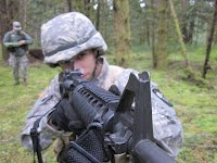 rotc student aiming a machine gun