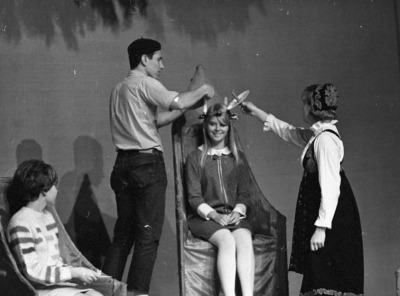 Student smiling as she participates in ceremony