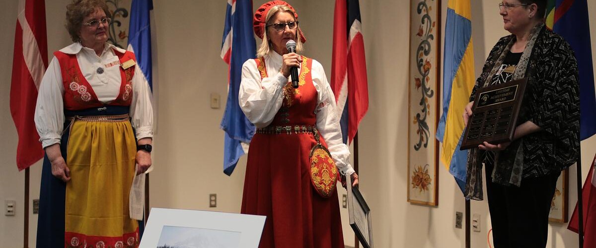 Linda Caspersen in traditional bunad, accepting a lifetime achievement award