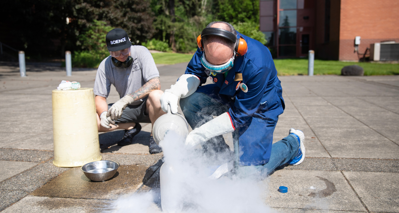 Two physics professors work an experiment outside of Rieke