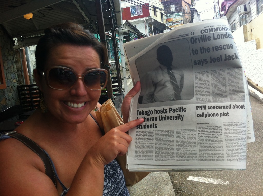 Social Work Class in Tobago, student pointing at a newspaper about PLU students