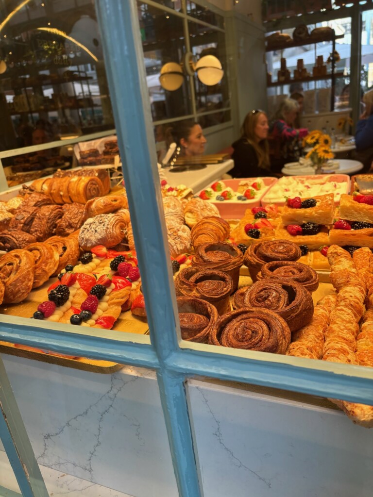 People & Culture_3rd_Amy Mbugua Pastries in cafe window in London