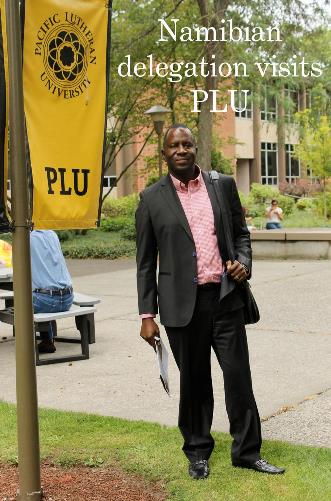 namibian-delegation One of the Namibian delegation members standing by a PLU flag on campus