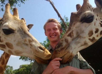 Nev Granum and two new giraffes in Uganda. Photo by Charles Bergman