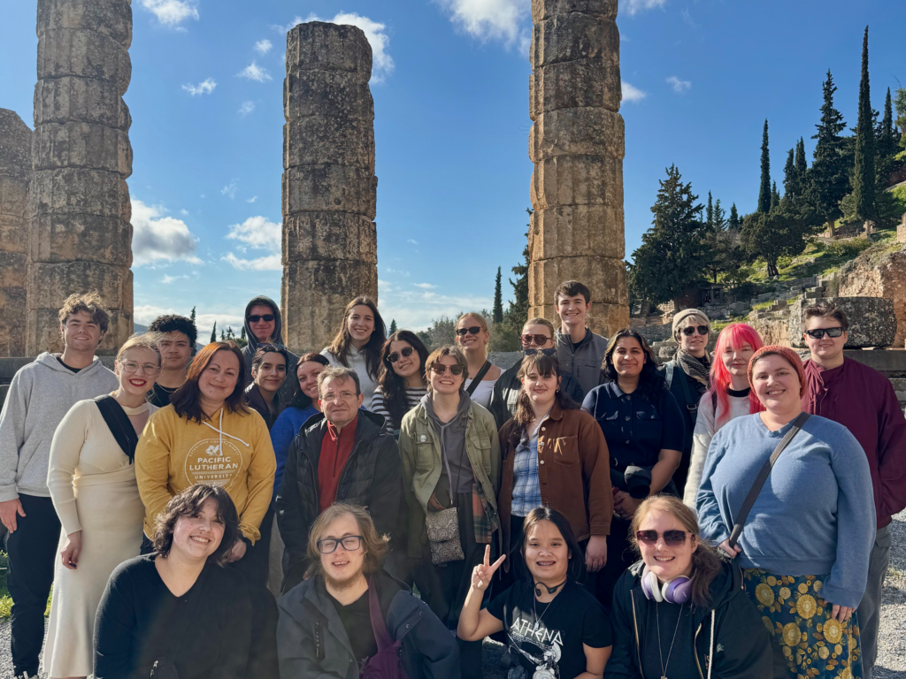 Group of students in front of stone pillars