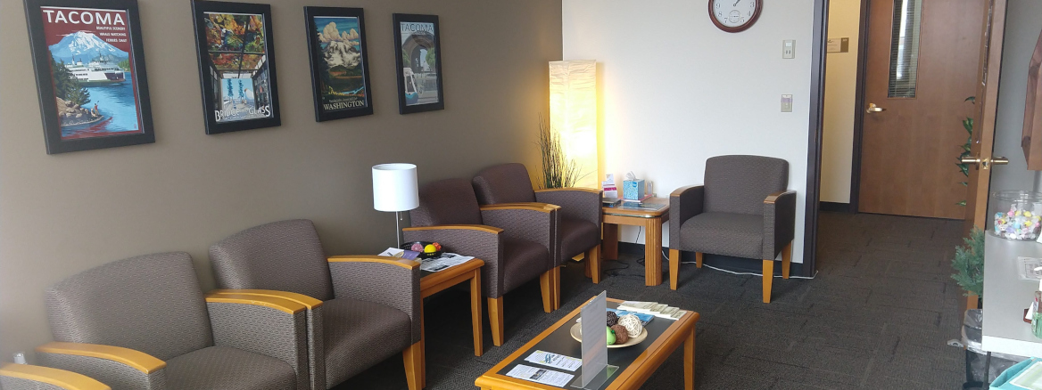 Counseling Center Reception Room featuring a table surrounded by chairs, with a stylish interior design and comfortable furniture.